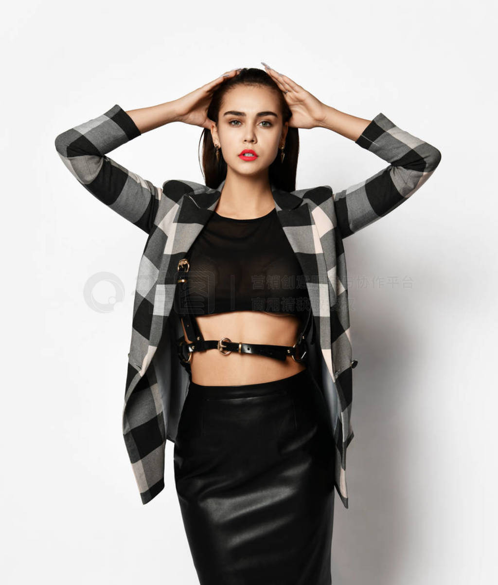 Young glamorous modern girl in a checkered jacket and black skir