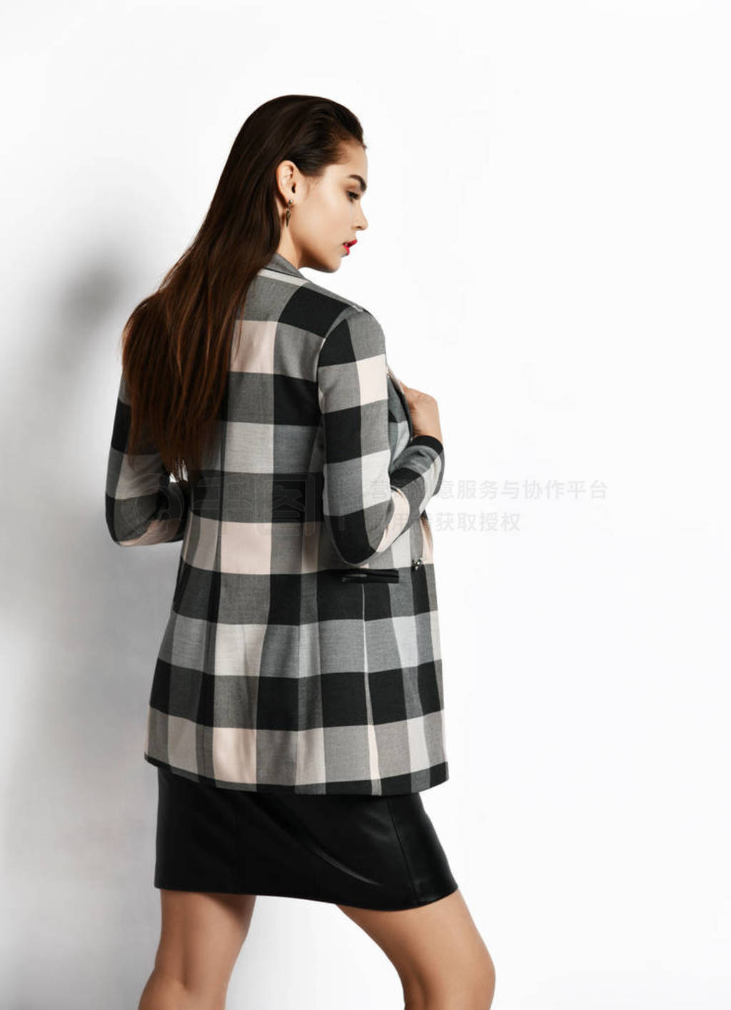 Young glamorous modern girl in a checkered jacket and black skir