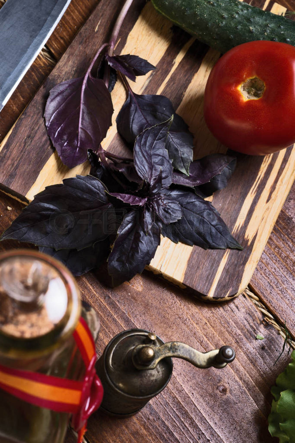 cooking green salad from fresh organic vegetables, basilic and