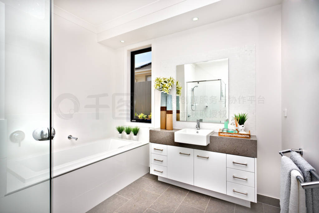 Washroom with a bath tub beside a window and tap