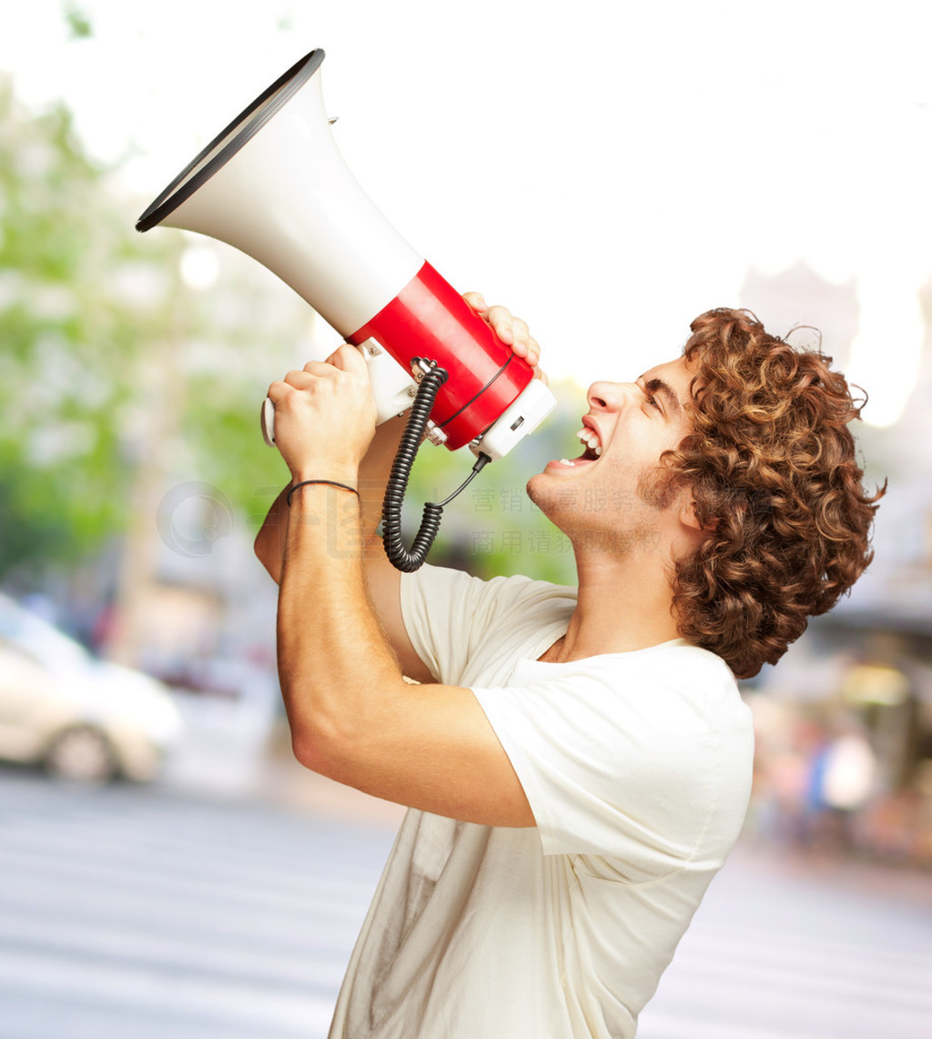 Portrait Of Young Man Shouting With A Megaphone?