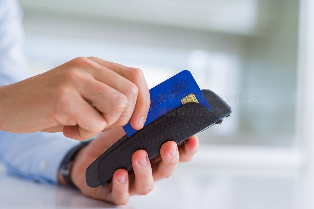 Close up of man hands holding pos terminal