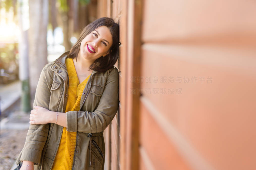 Beautiful young woman smiling confident and cheerful leaning on