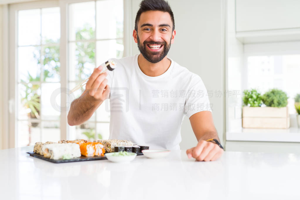 Handsome man smiling happy enjoying eating fresh colorful asian