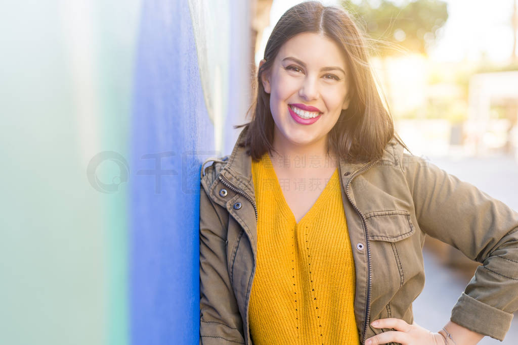 Beautiful young woman smiling confident and cheerful leaning on