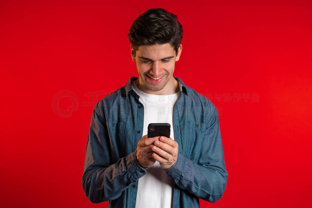Man sms texting using app on smartphone. Handsome young guy surf