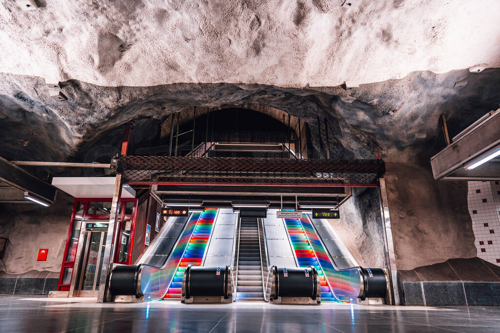 Empty subway station with escalators and colorful stairs. Public