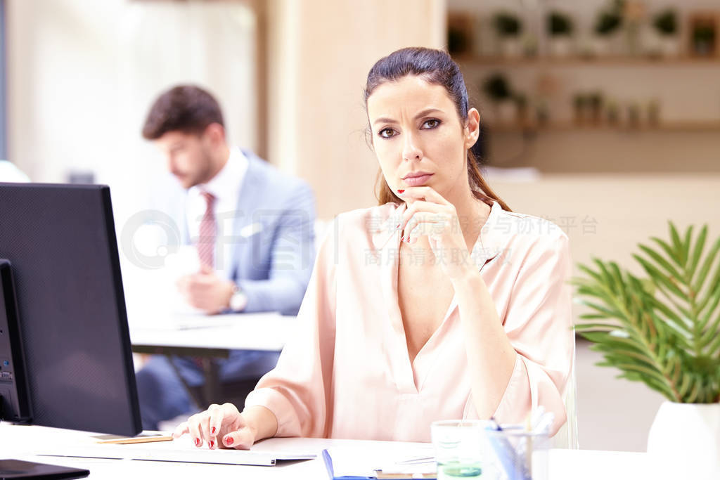 Beautiful businesswoman looking nervous while sitting at office