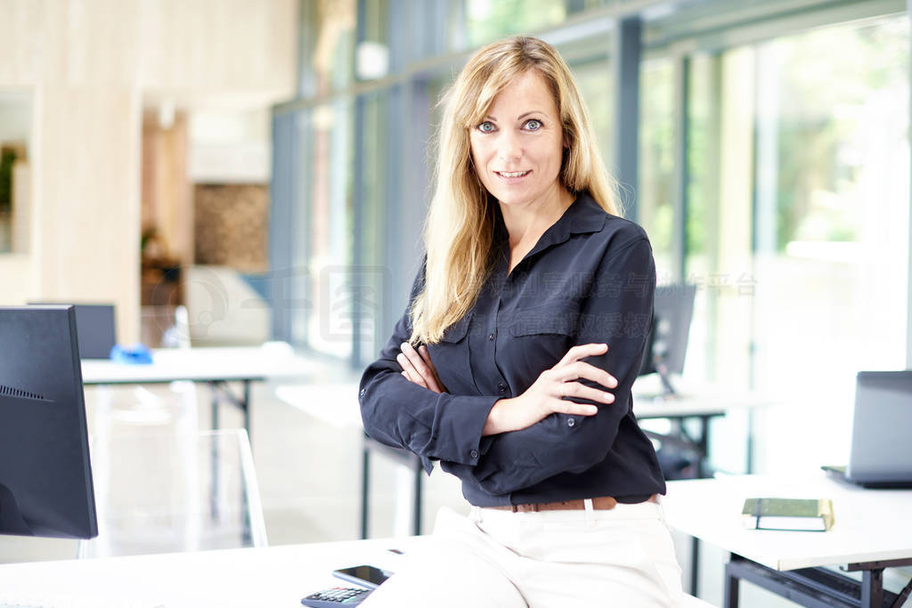 Attractive businesswoman standing in the office