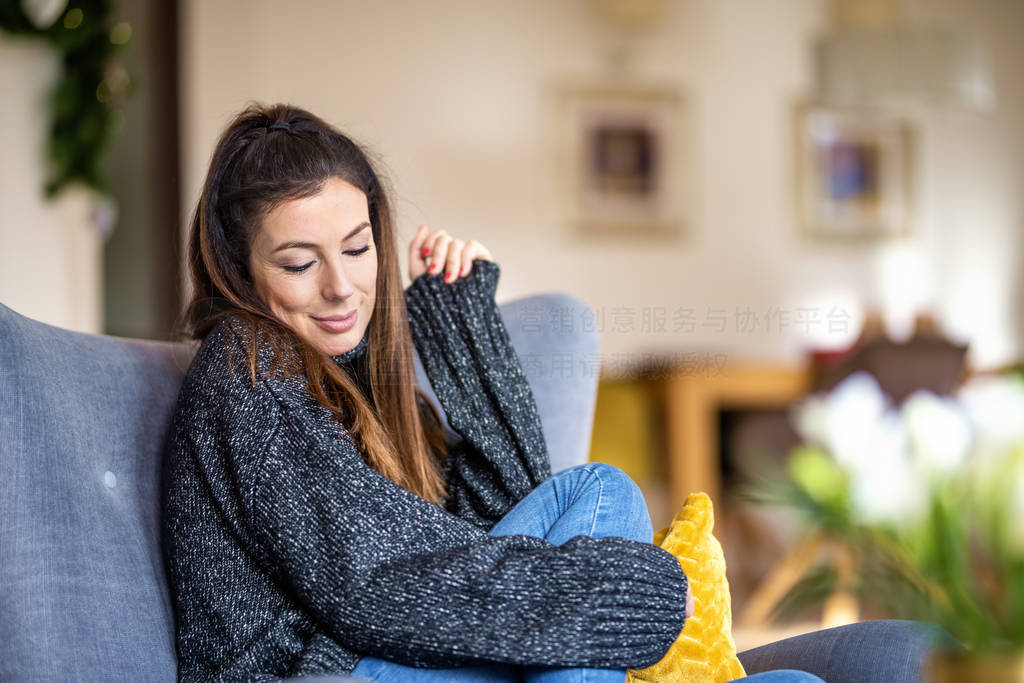 Relaxe woman relaxing in the armchair at home