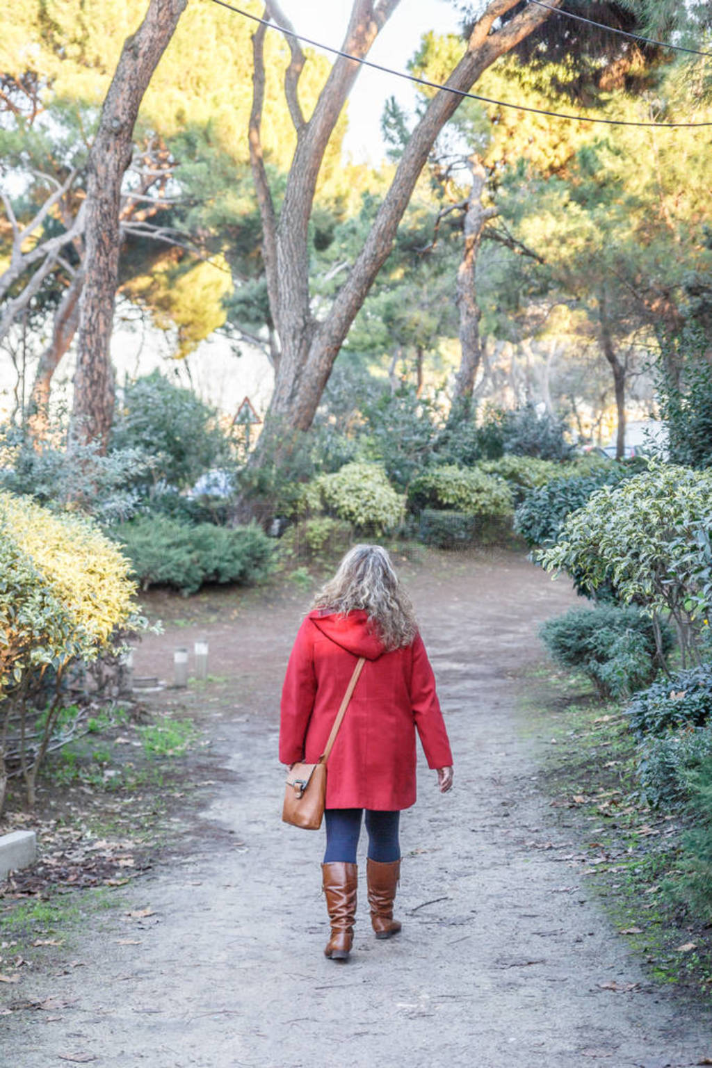 A woman walks in the middle of a lonely forest in the middle of