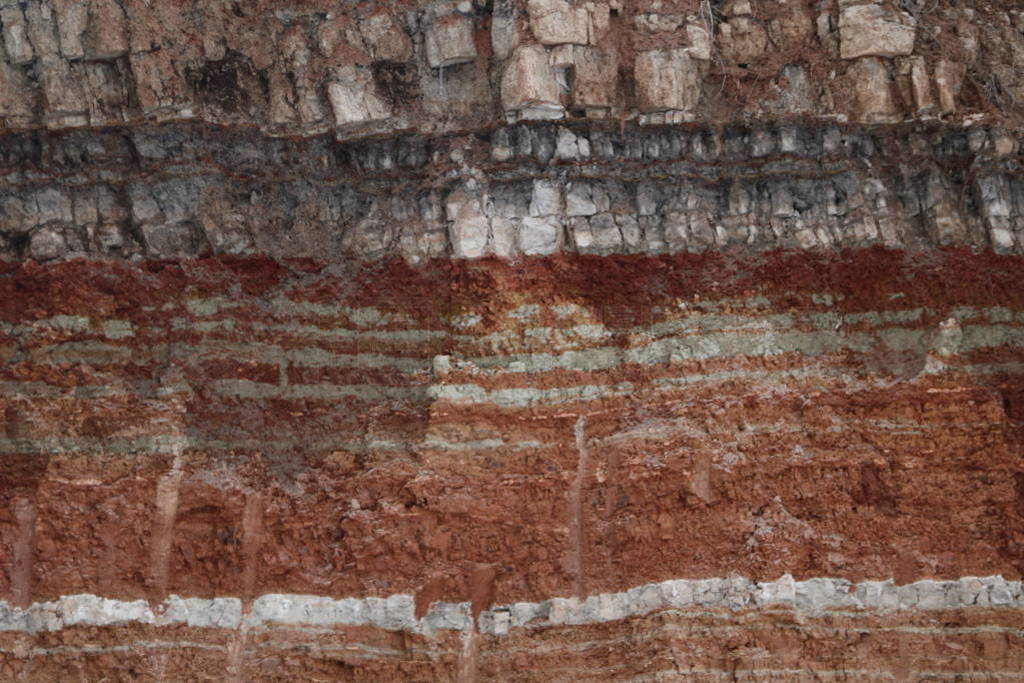 texture of different layers of clay underground in clay quarry