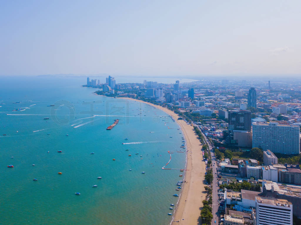 Aerial view of boats in Pattaya sea, beach, and urban city with