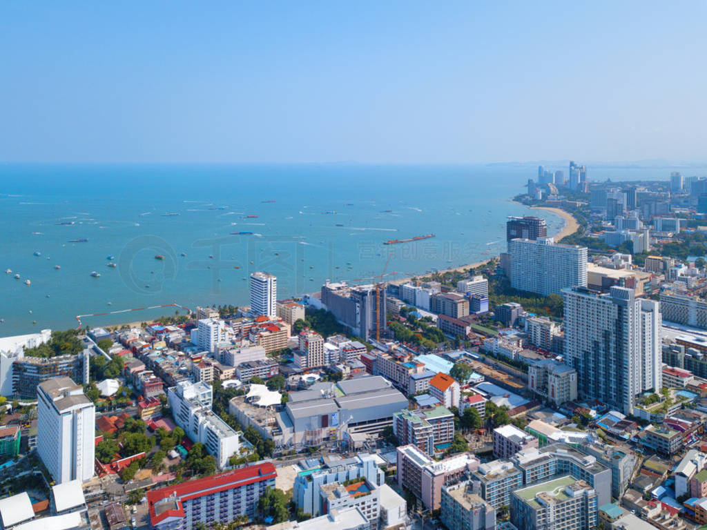 Aerial view of boats in Pattaya sea, beach, and urban city with