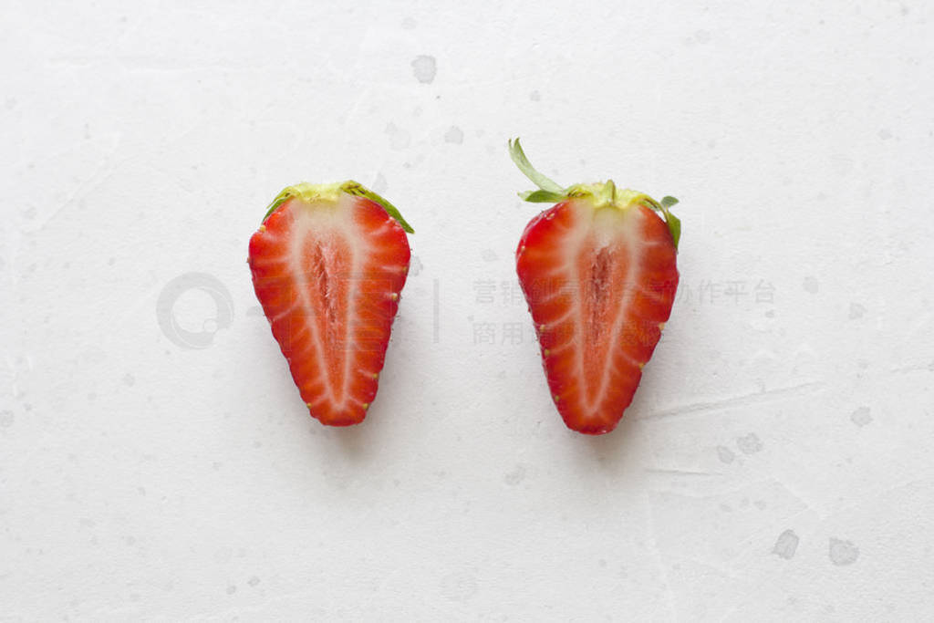 Two halves of strawberries. Cut red beautiful strawberries on a