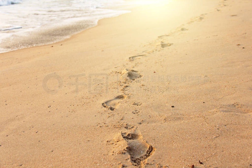 Footprints in the sand against the background of the sea. Place