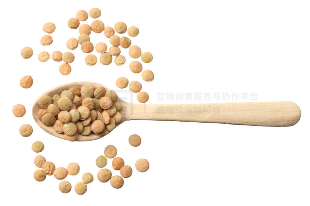 Pile lentil in wooden spoon isolated on white background. Top vi