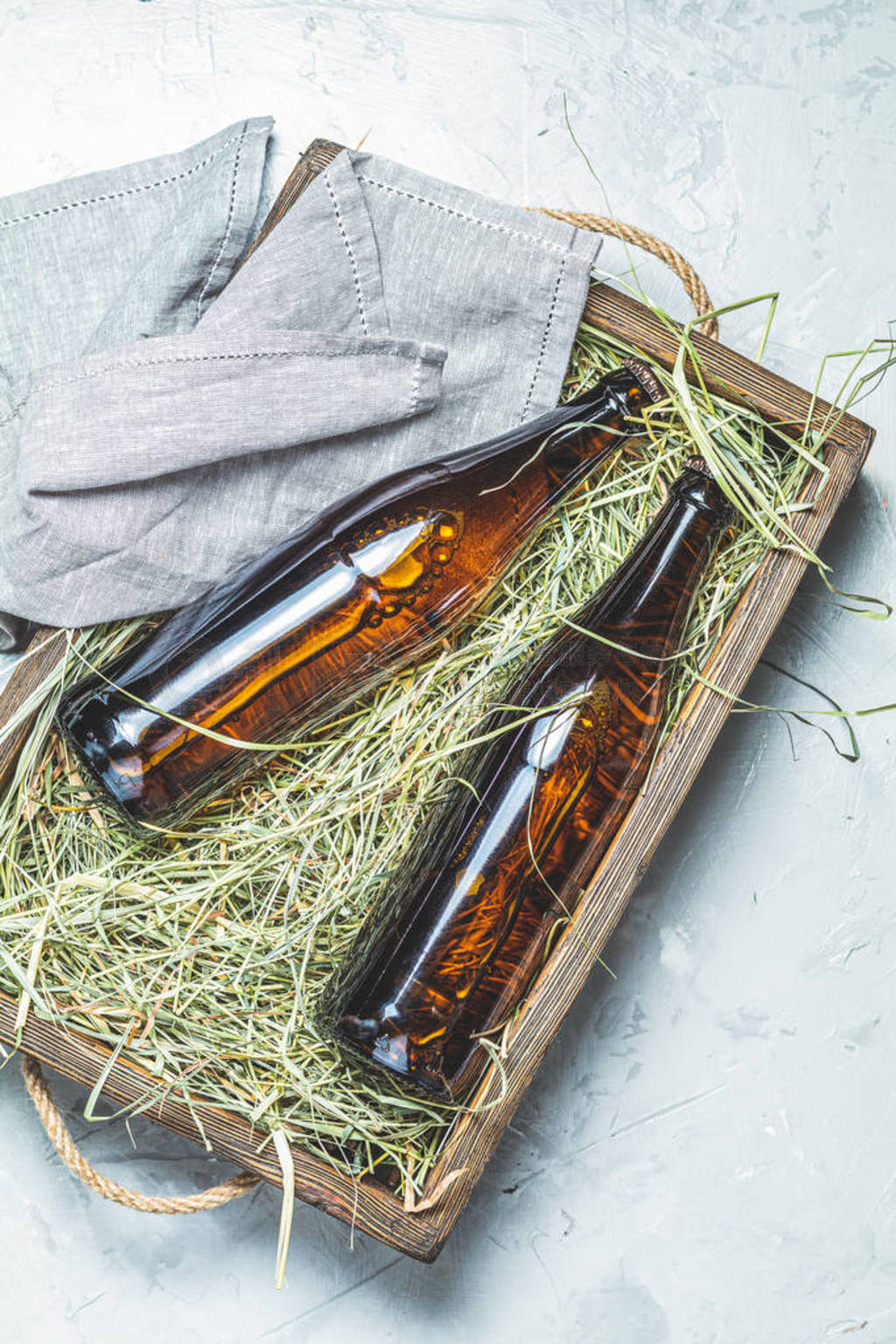 Craft beer with dried grass in wooden box