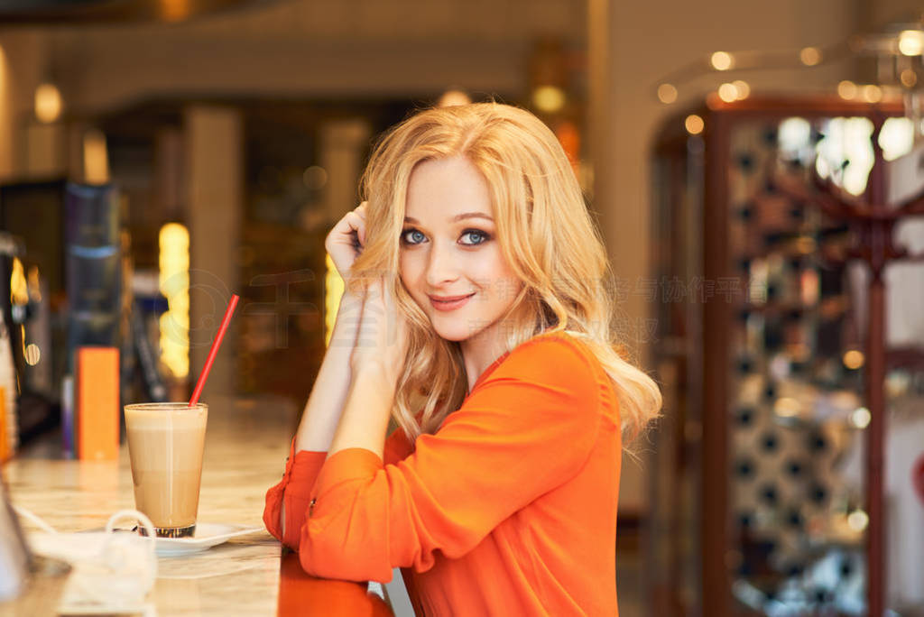 young lady is sitting at bar, smiling pleasantly