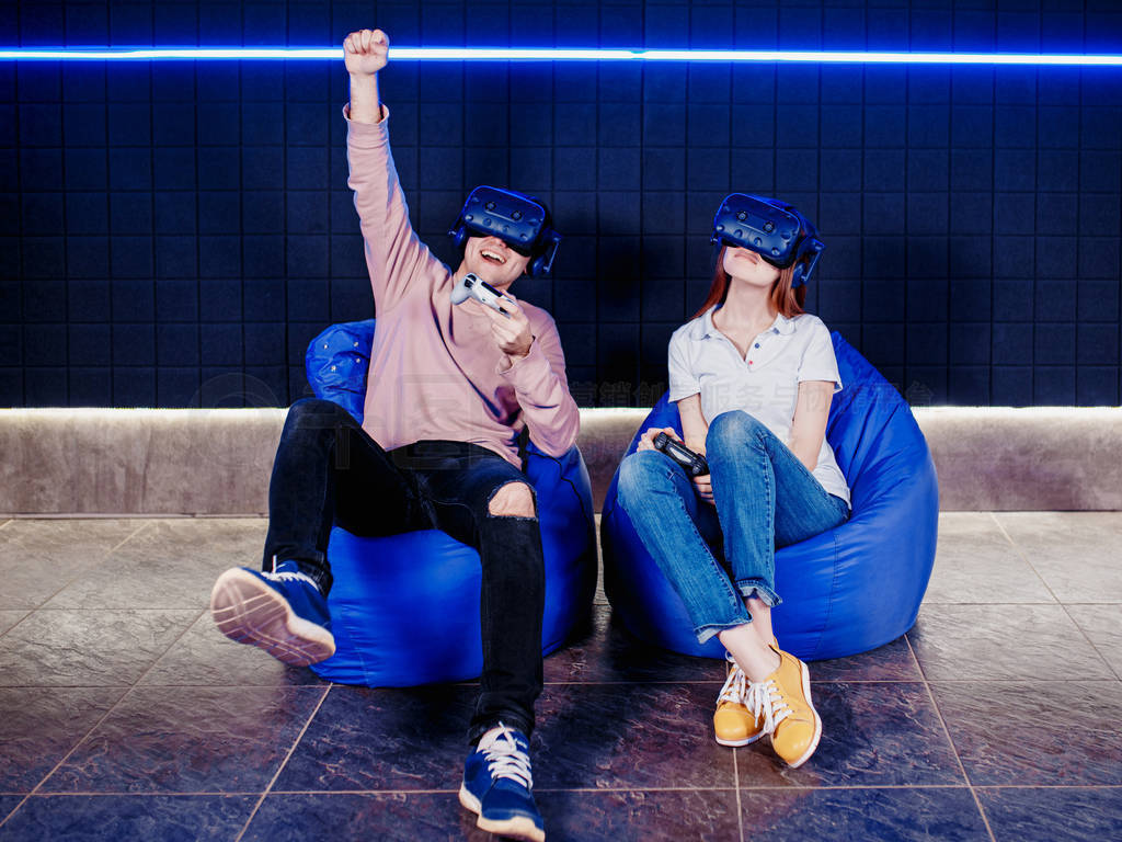 young guy and girl play in a virtual reality helmet