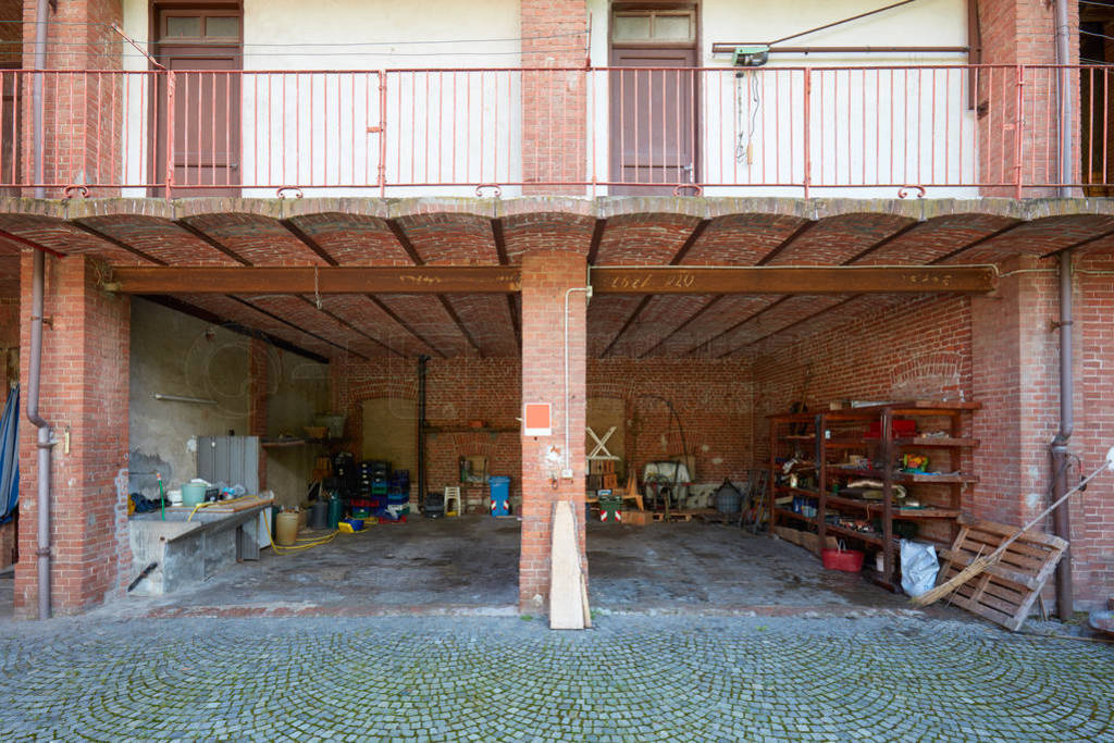 Old country house with messy deposit and brick walls in a sunny