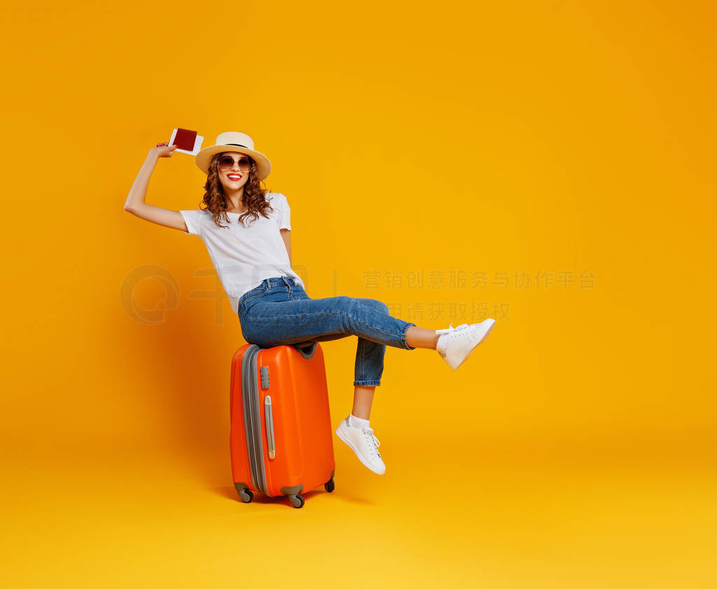 concept of travel. happy woman girl with suitcase and passport