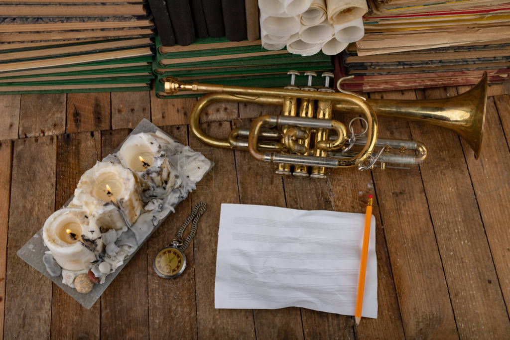 Old trumpet covered with patina on an old wooden table. Musical