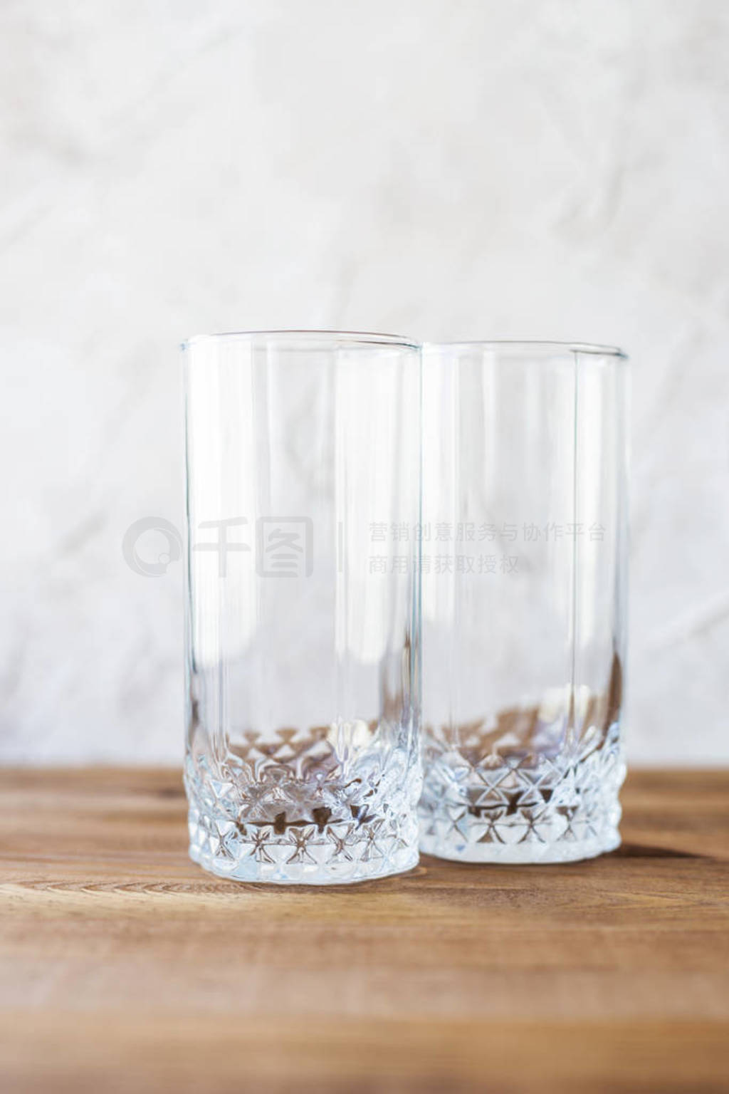 Empty glasses on light background