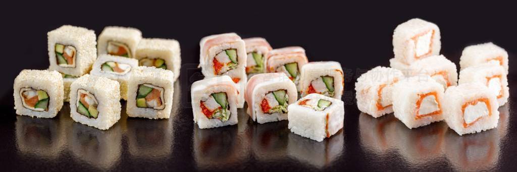 Elite sushi rolls on a black background. Assortment of rolls wit