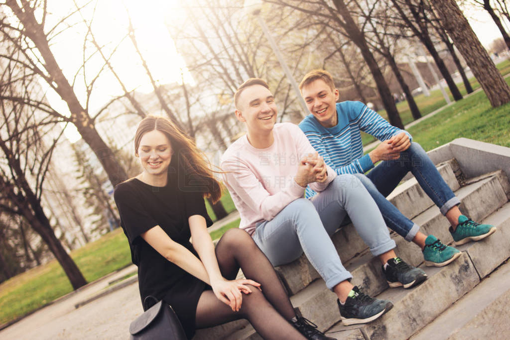 Group of friends Millennials students teenagers sitting at city