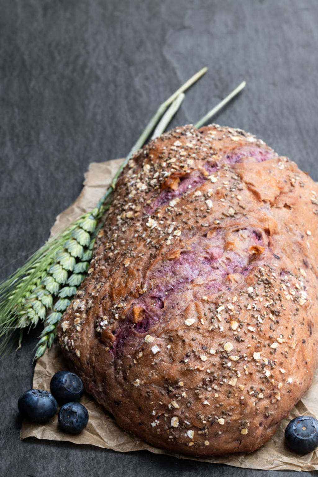 Blueberry and chia seed bloomer on black stone table