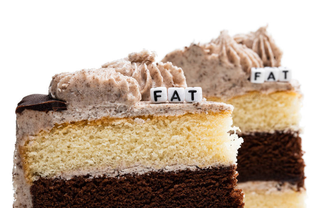 Concept of unhealthy fat food. Pieces of layered sponge cake iso