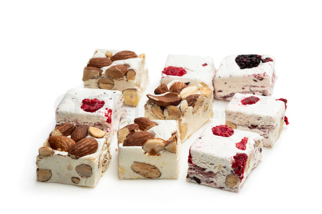 Homemade nougat bars with almonds and dried fruits isolated on w