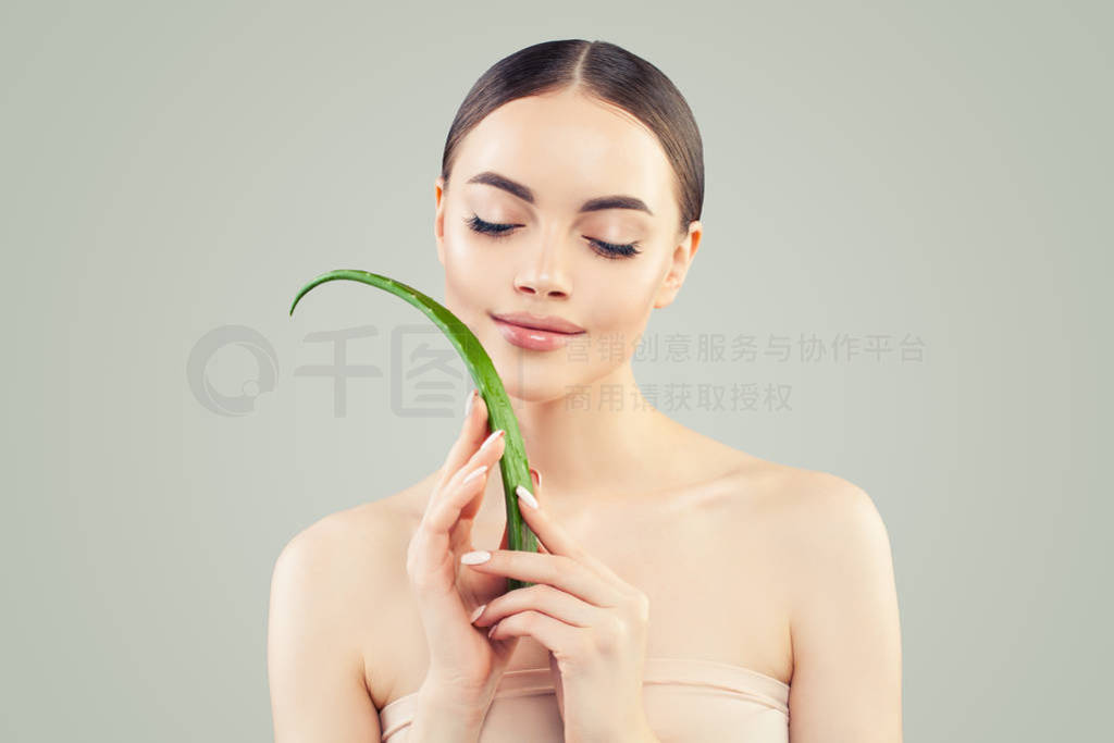 Perfect young woman with aloe vera leaf, skincare