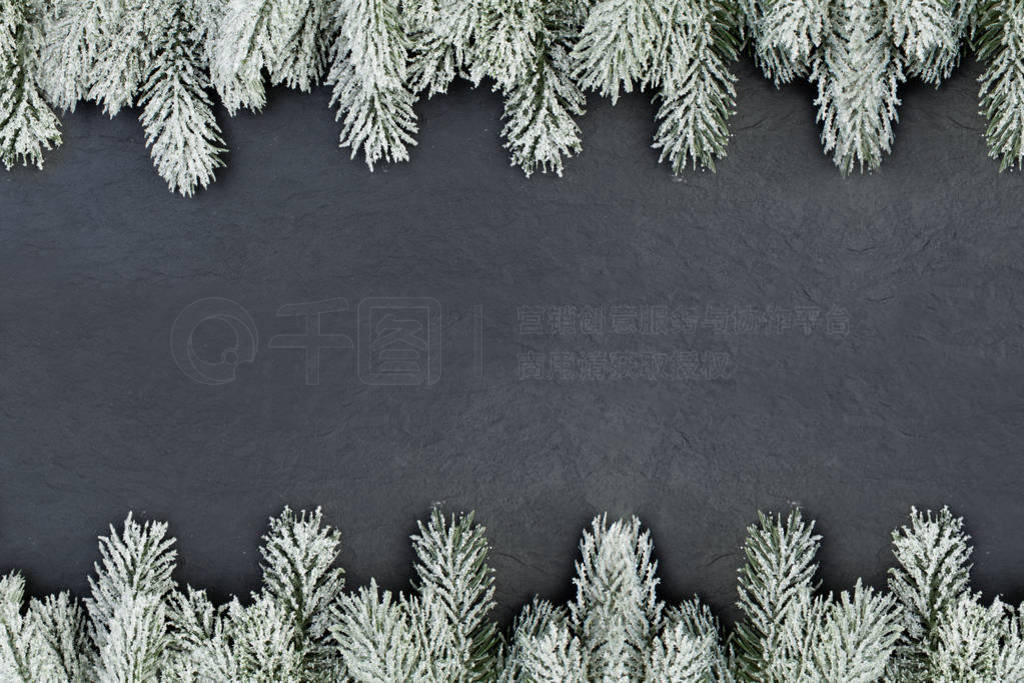 Christmas tree branch border on black, flat lay top view.