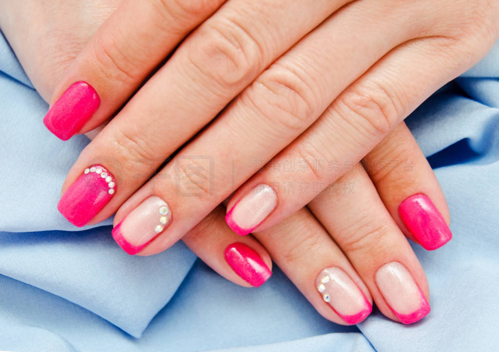 Woman's nails with beautiful pink manicure fashion design