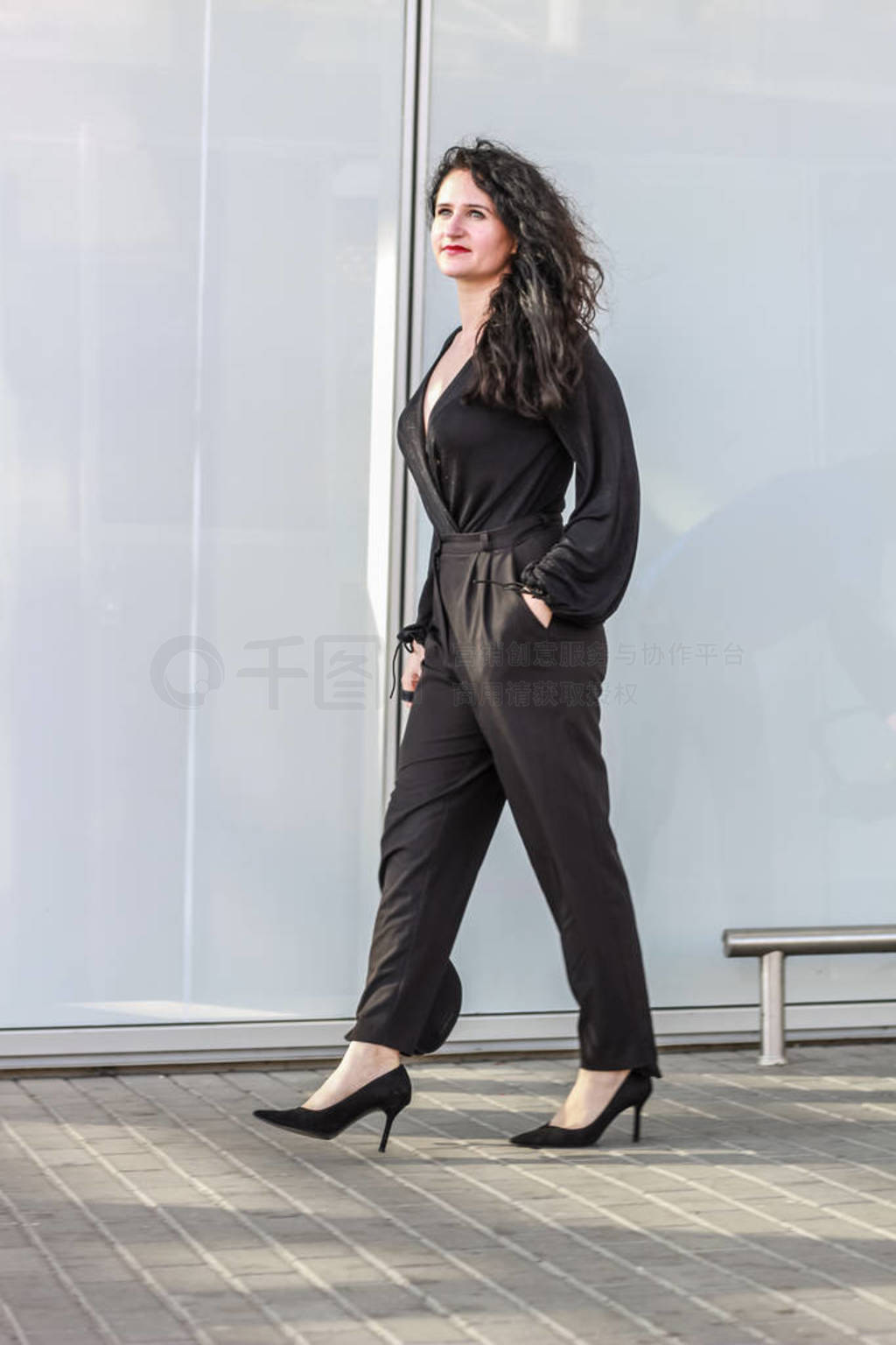 Black-haired girl. Stylish business woman. Black overalls. Suit