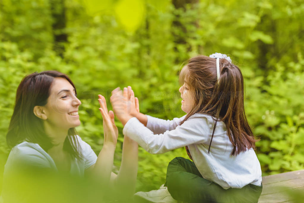 Young mom and her little girl have fun together