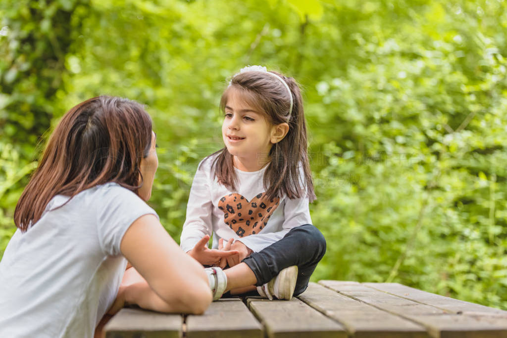 Young mom and her little girl have fun together