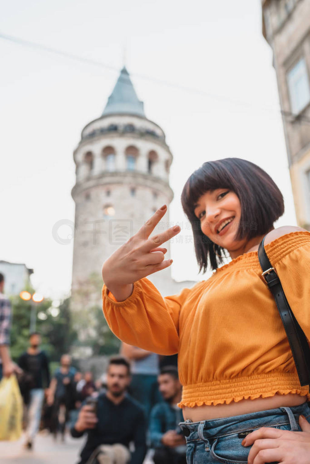 Beautiful woman stands in front of Galata tower