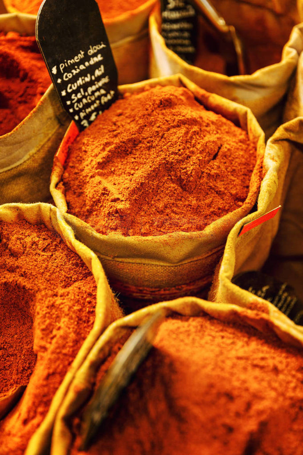 Bright oriental spices in bags on the counter. Close-up.