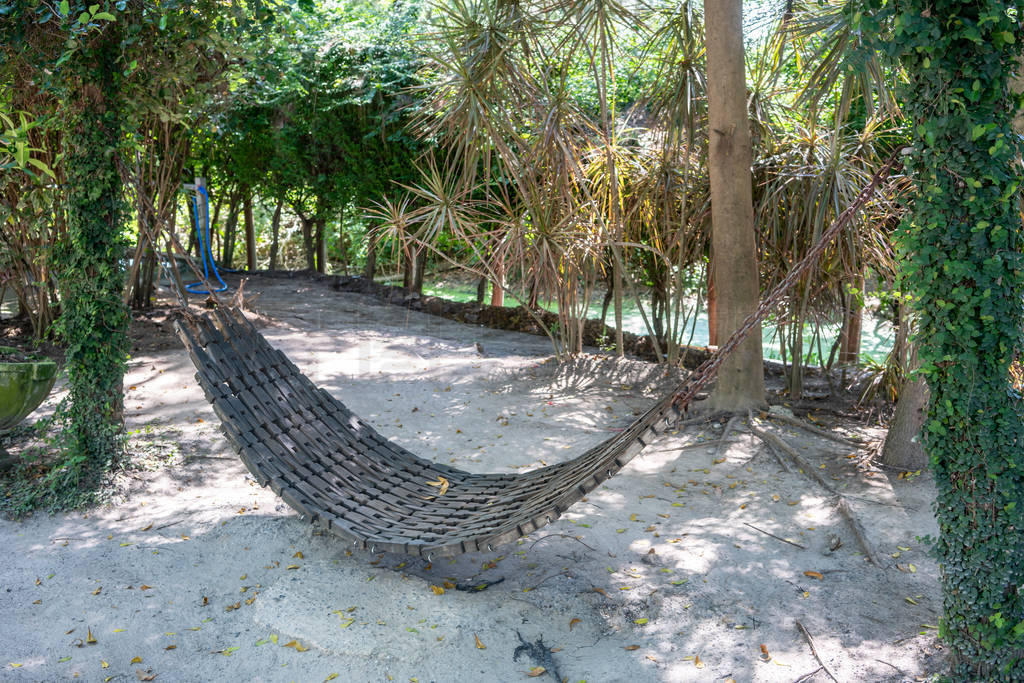 Dirty wood hammock made from black PU foam in backyard