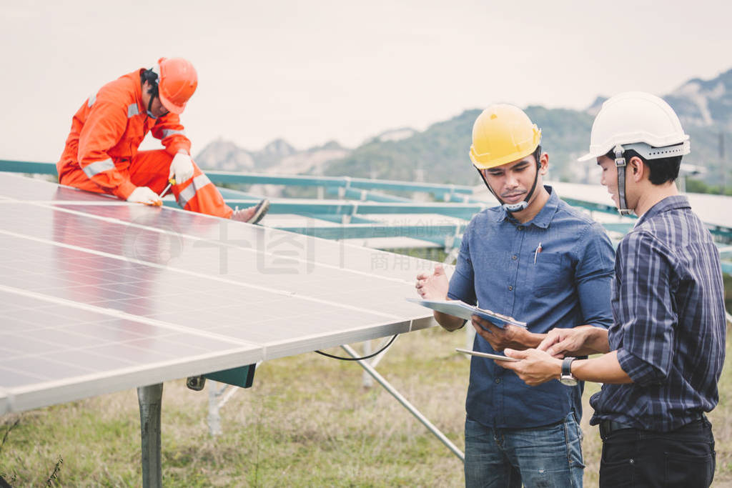 engineer in solar power plant working on installing solar panel