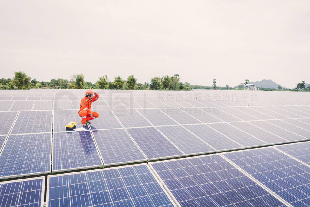 engineer in solar power plant working on installing solar panel