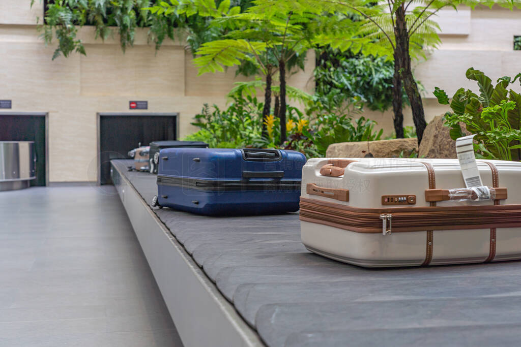 Passenger luggage on conveyor belt at arrival terminal in airpor