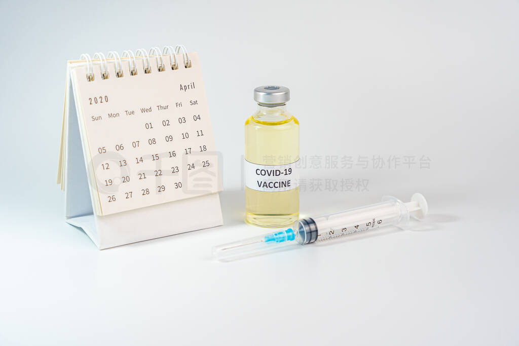 Studio shot of Covid-19 vaccine bottle and 2020 calendar