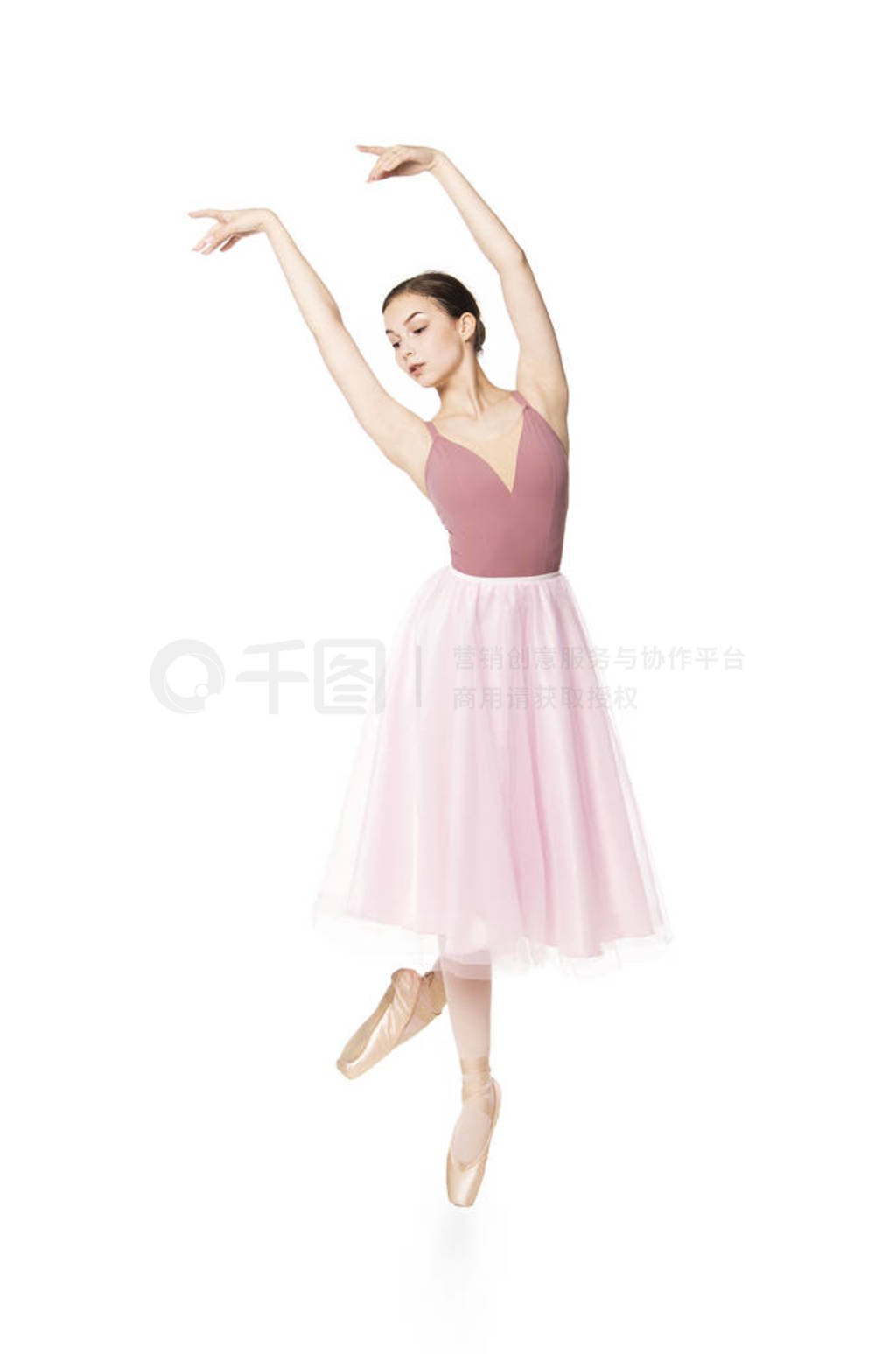 Elegant girl in a pink skirt and beige top dancing ballet.