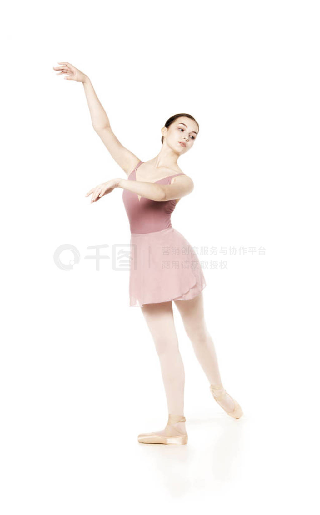 Elegant girl in a pink skirt and beige top dancing ballet.