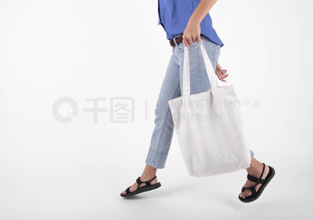 Girl is holding bag canvas fabric for mockup blank template