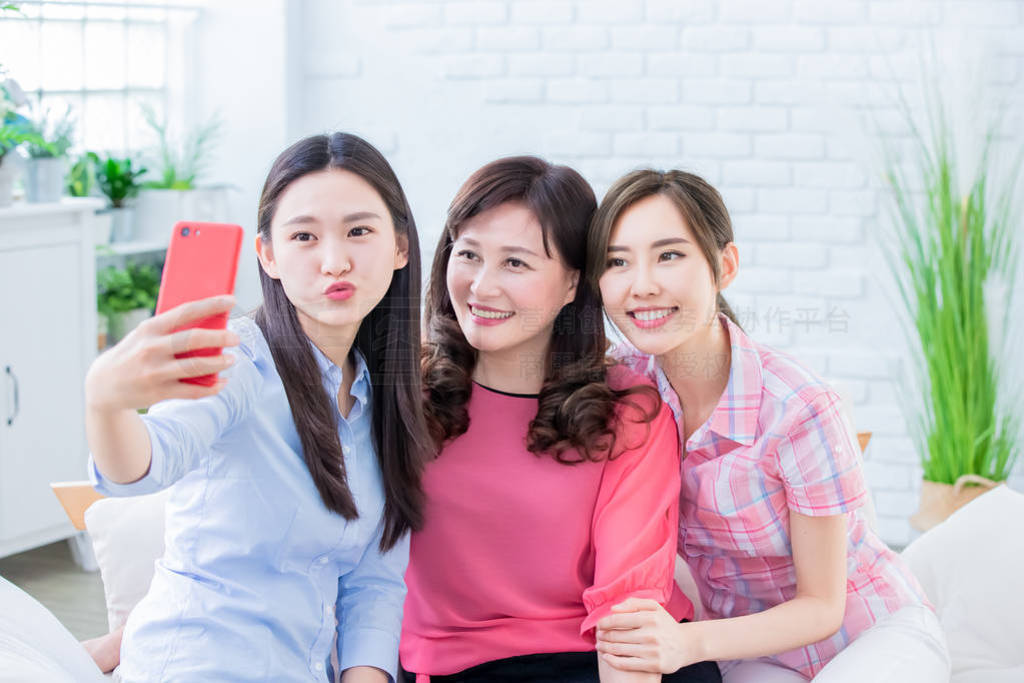 Daughters and mom take selfie